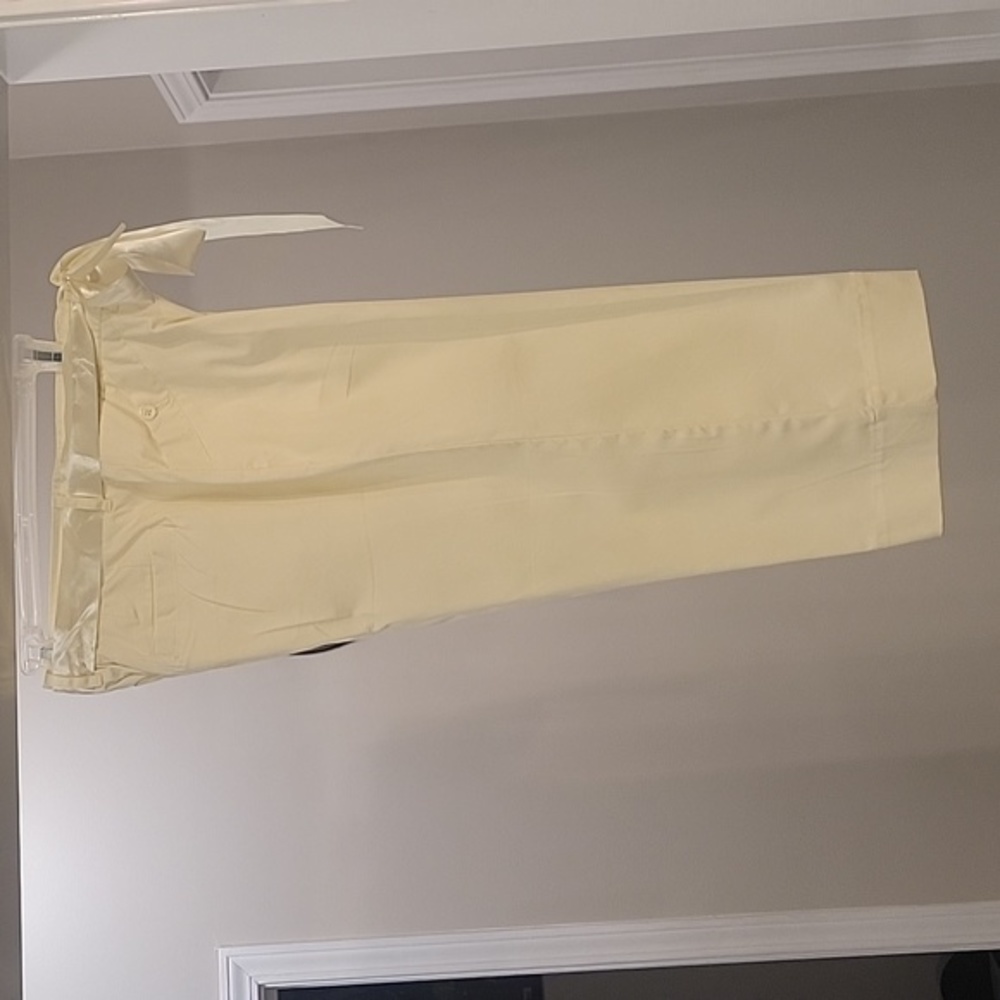 A pair of yellow capris with a ribbon belt